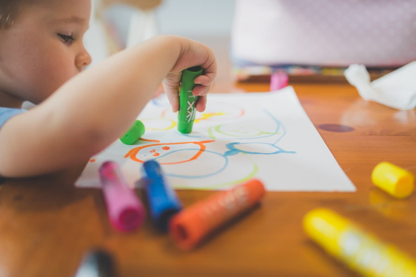 A young boy focused on drawing at a table